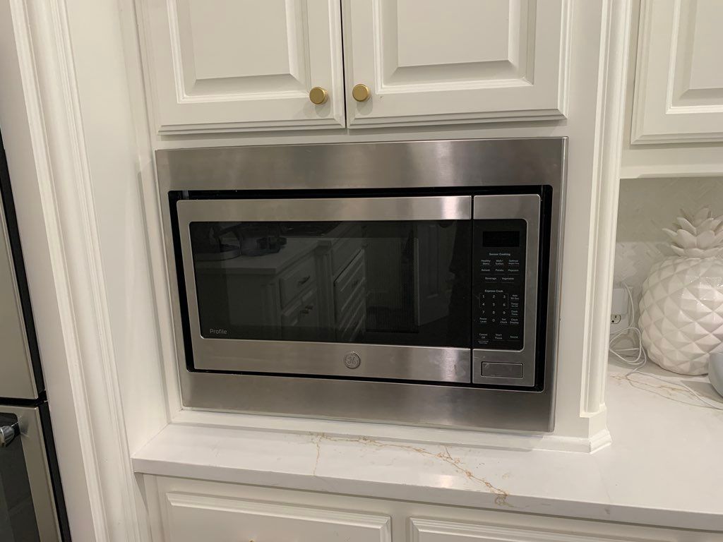 Unsecured Microwave reinstall with finishing trim 