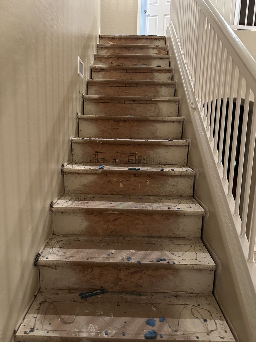 Before - Staircase had brown carpeting.