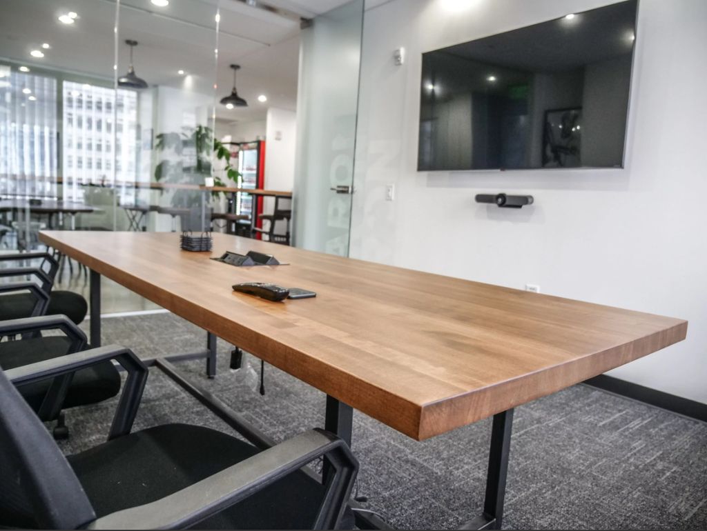 TV and soundbar mounted in a conference room in At
