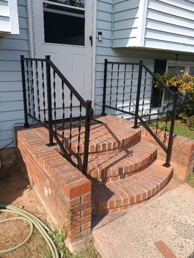 The railing has been welded, sanded, and painted.