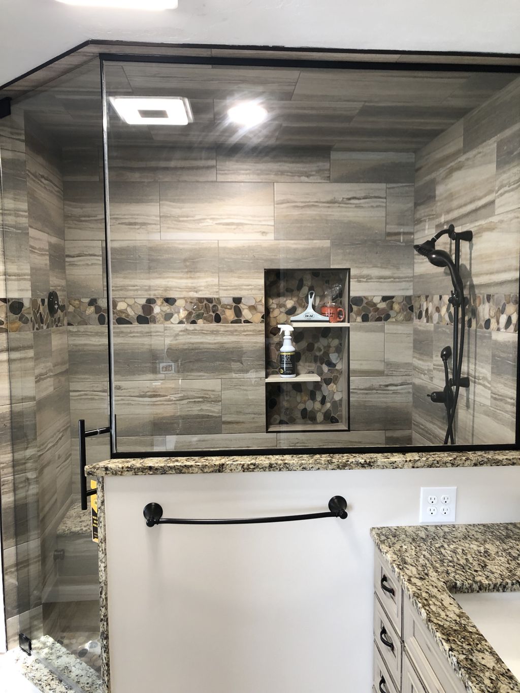 Tile shower with steam, accent strip, bench with g