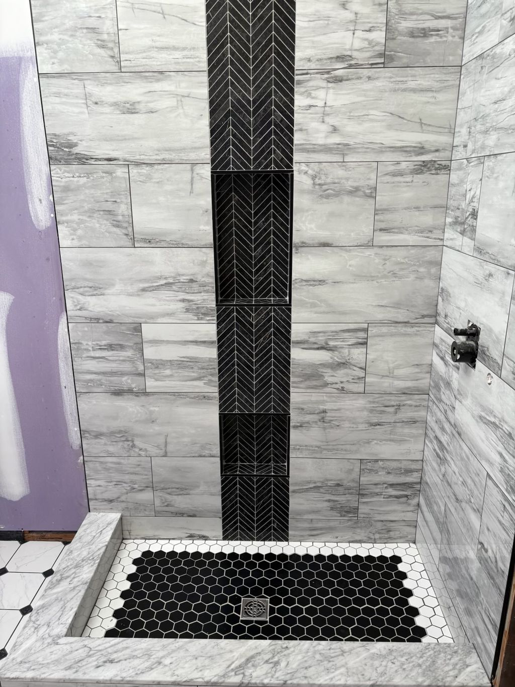 Custom tile shower with chevron accent strip and 2