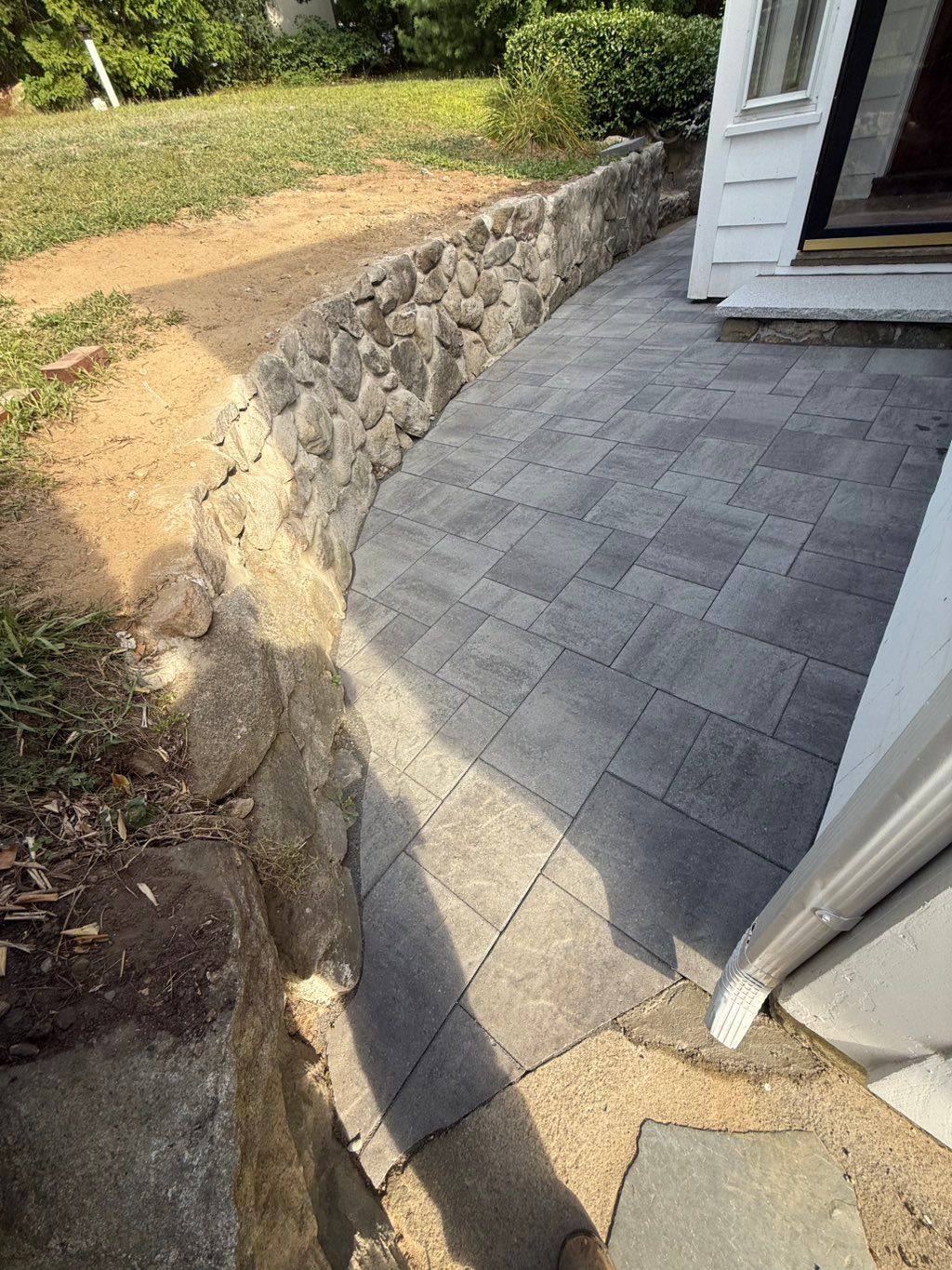 After we fix the stone wall and we add paver for t