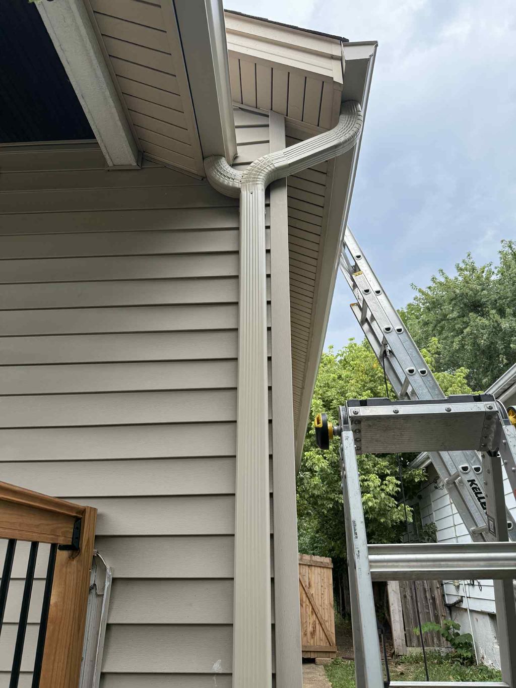 Two gutters into one downspout.