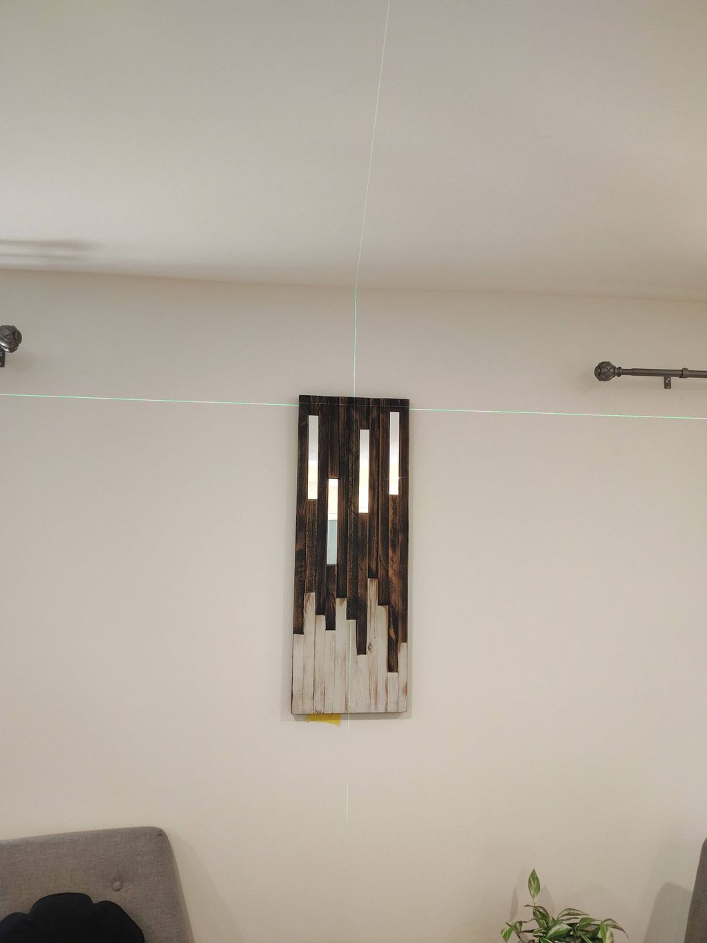 using laser to center wall and hang art work prope