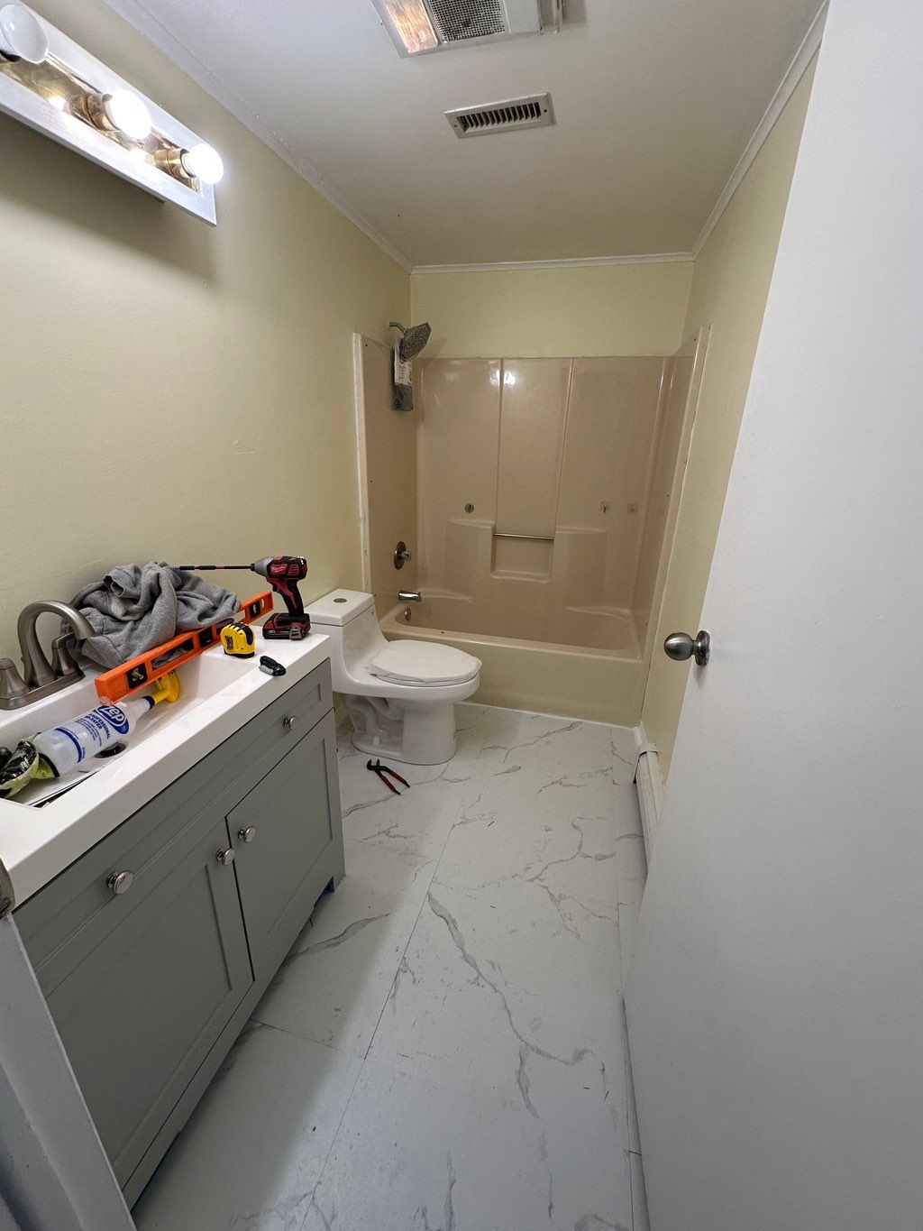 Upgraded vanity, installed peel & stick floors, re