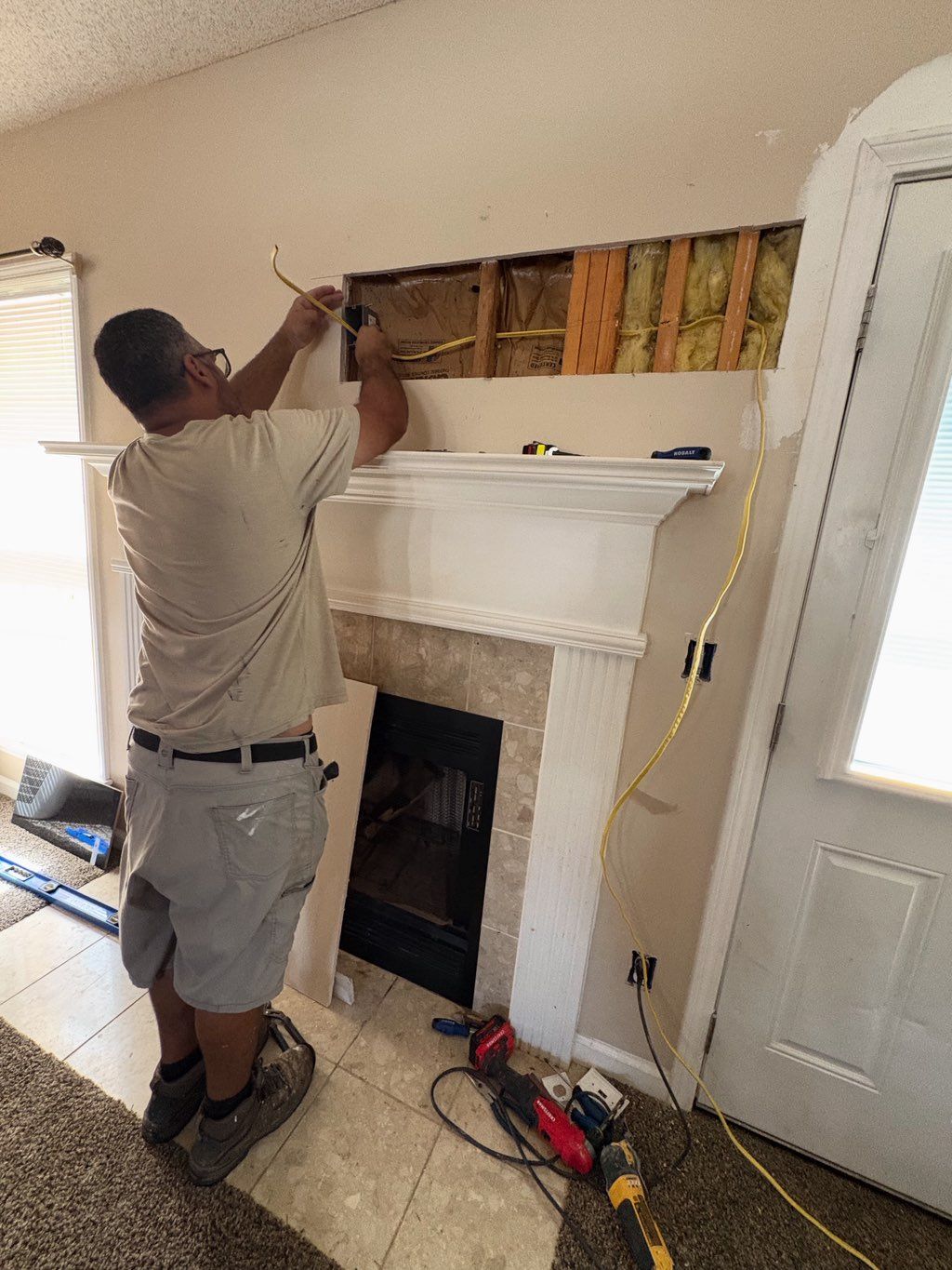 Added outlet above fireplace. Included drywall cut