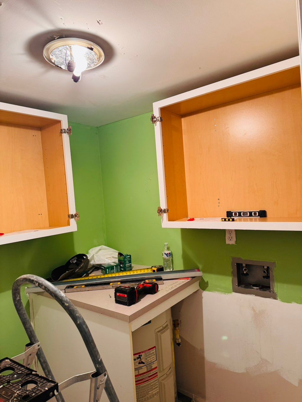 Installing cabinet in the laundry room 