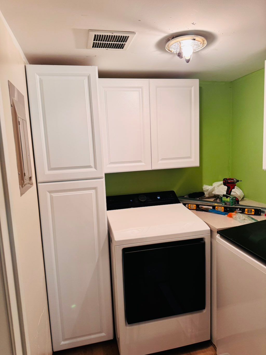 Cabinets installed in the laundry room done . 