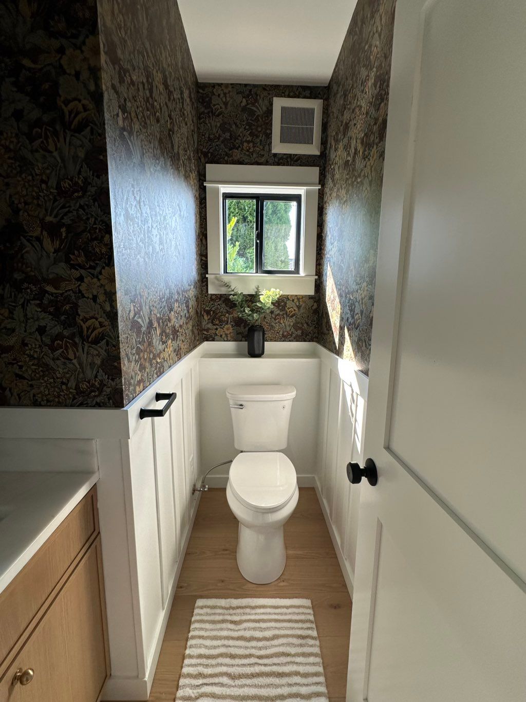 Elegant powder room remodel with custom wainscotin