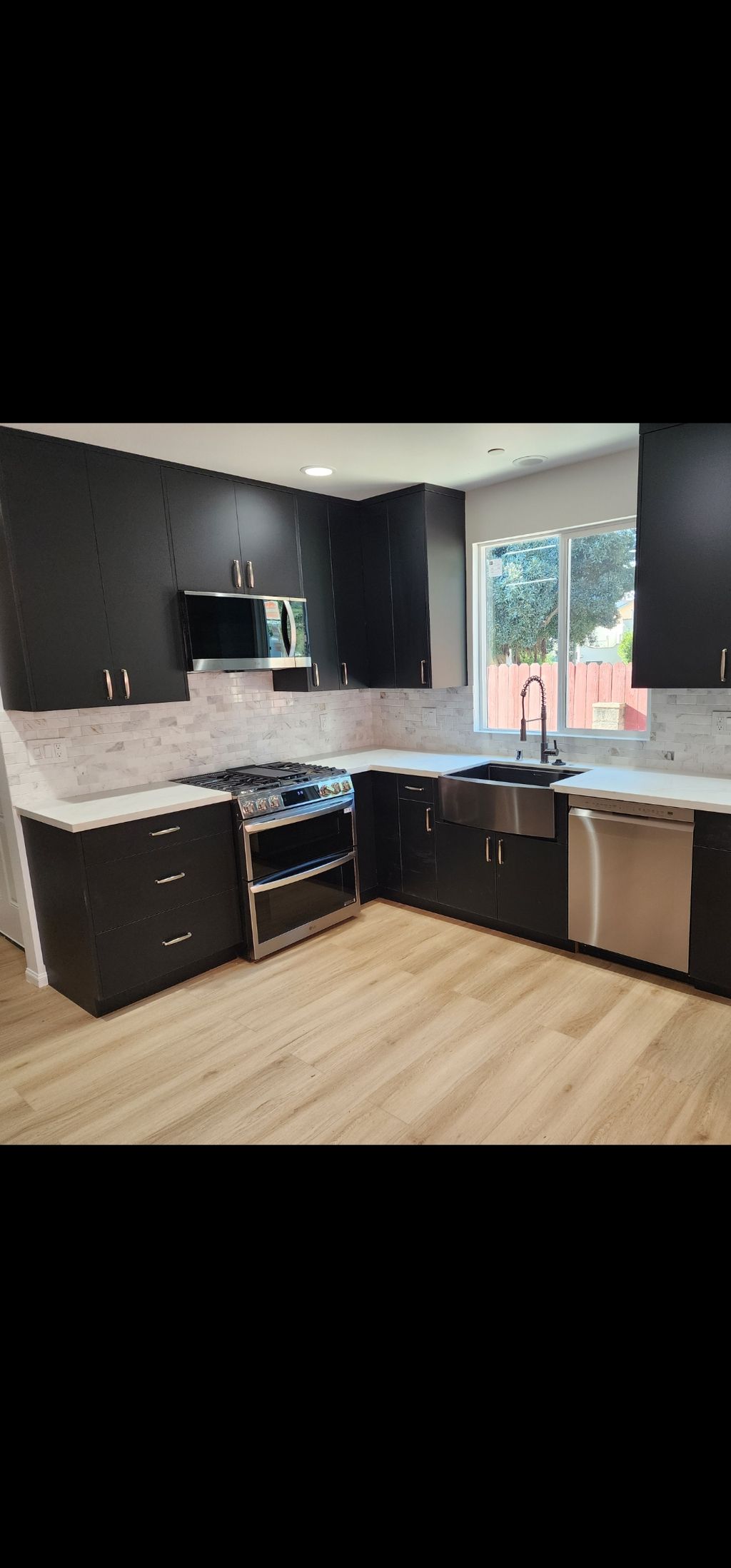 #2 Sleek, modern kitchen with black cabinets, stai