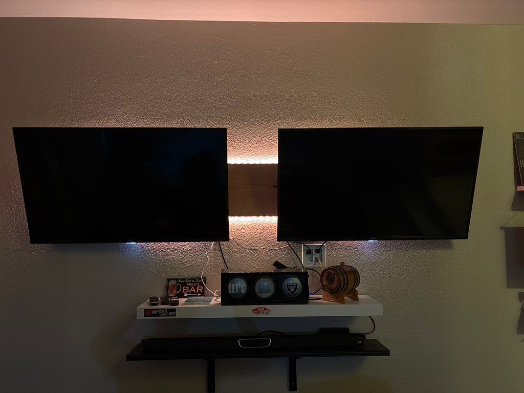 Hung two tvs in a bar room.