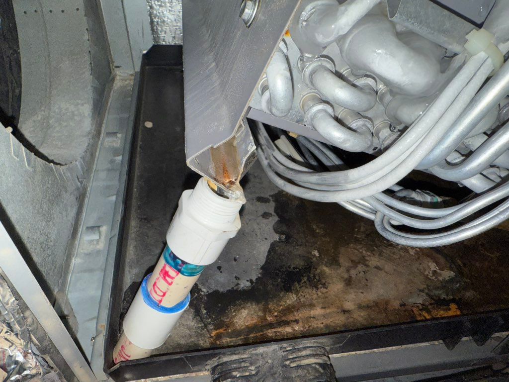 Indoor coil being held up by a piece of pvc . That