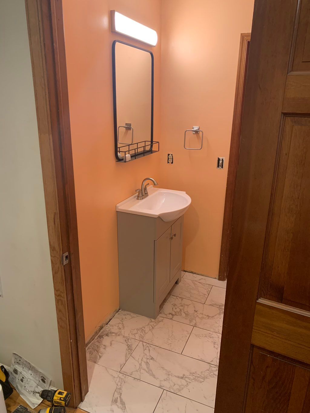 New vanity mirror and light installed in half bath