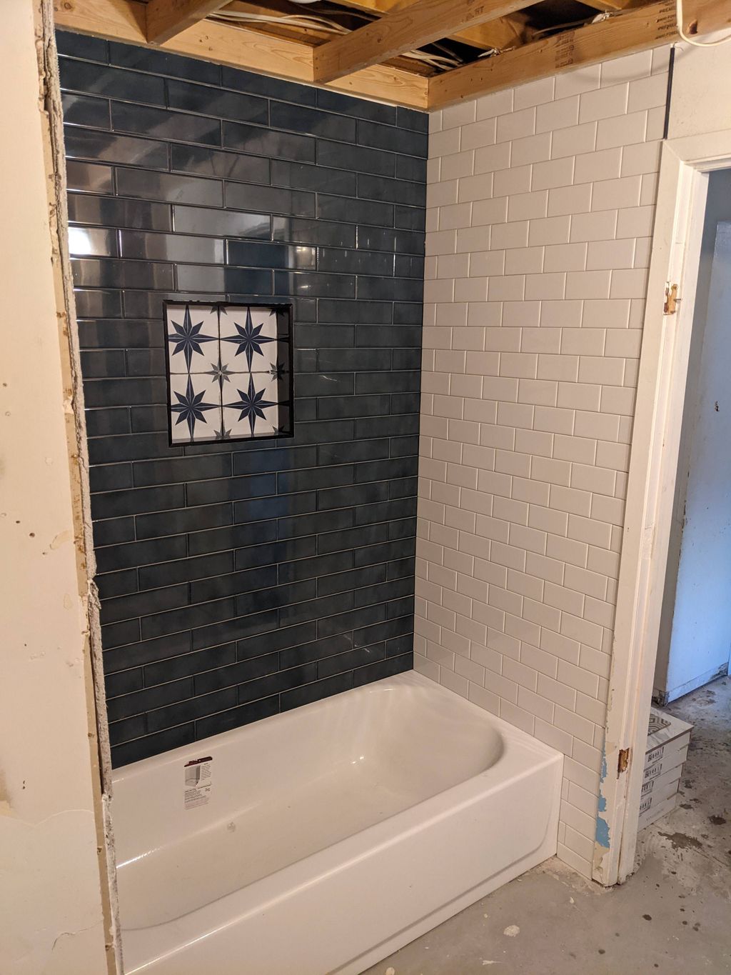 Tile installation with niche and schluter