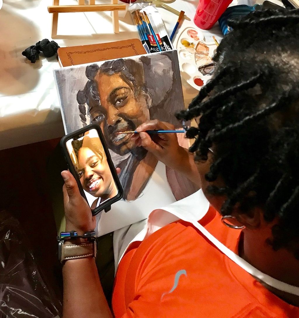 This is artist at work on painting on canvas. This