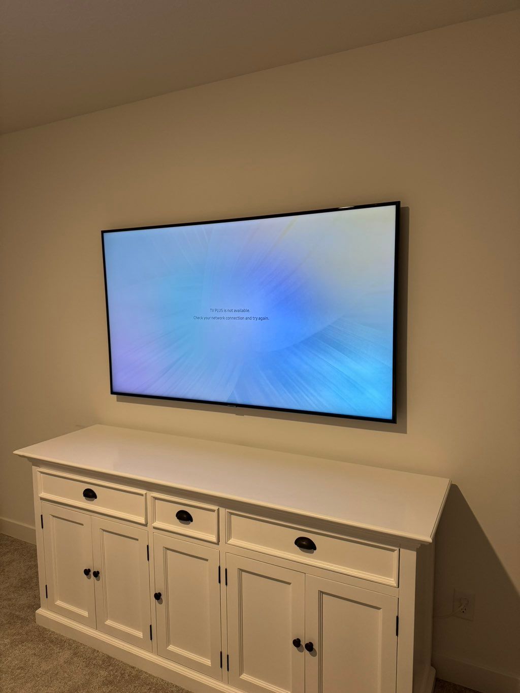 65’ TV mounted in drywall with concealed wires.