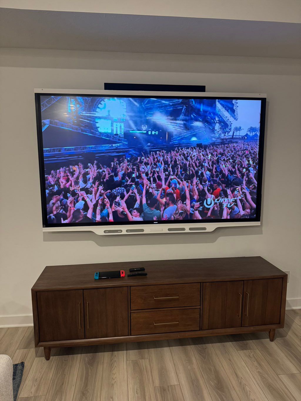 90’ TV mounted in drywall with concealed wires.