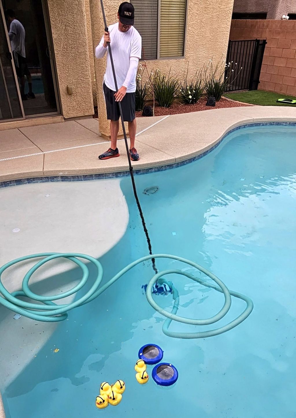 Owner Anthony vacuuming a pool