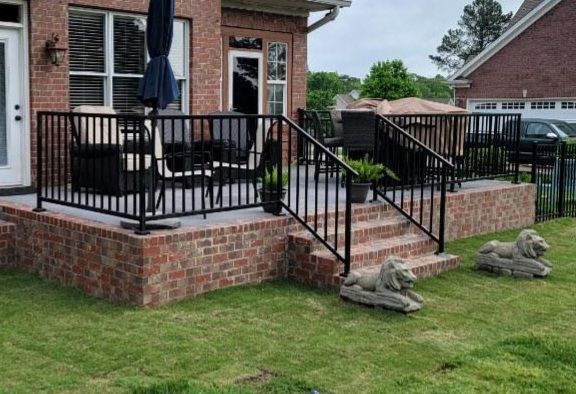 Brick porch with 2 sets of stairs and grilling spa