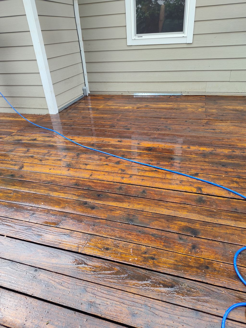 Power washed area of a deck we cleaned for a homeo