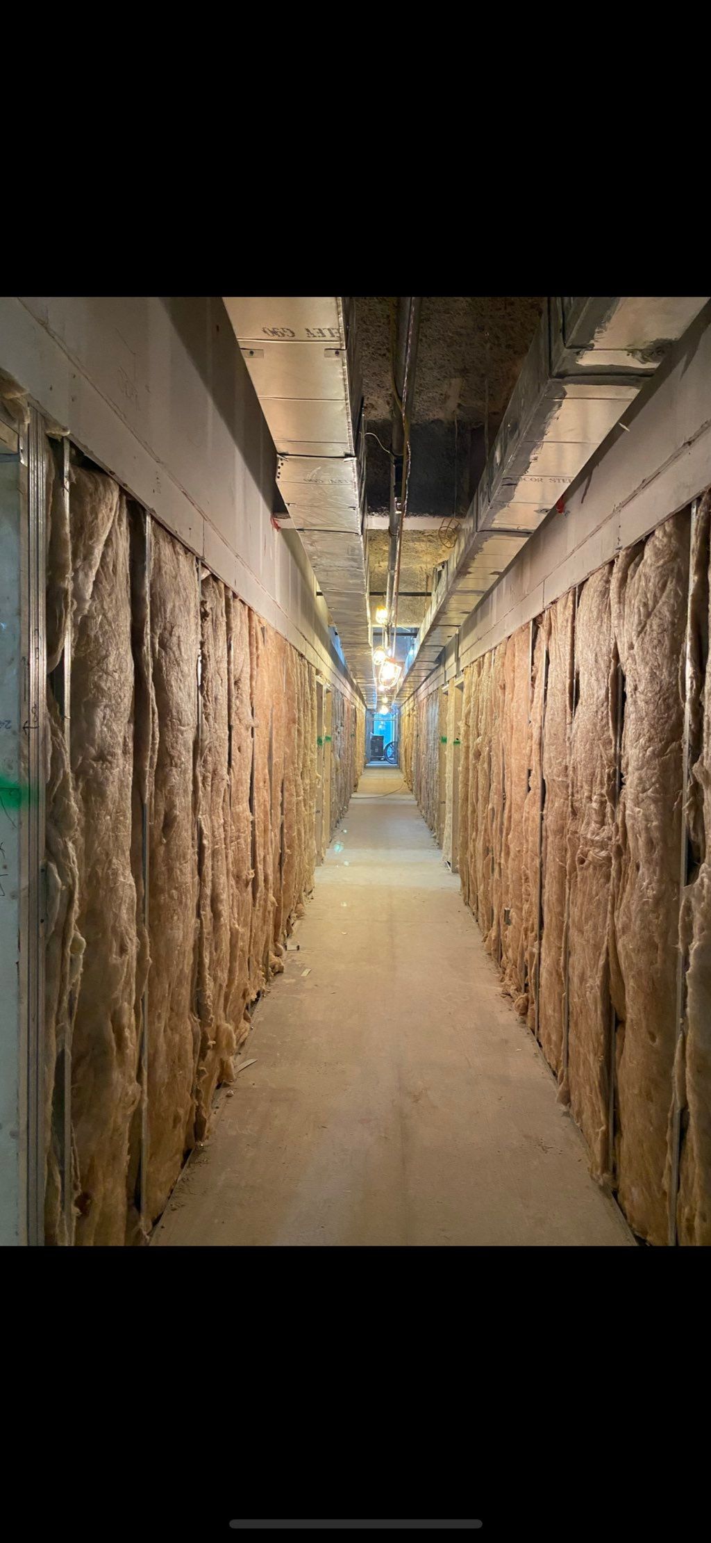 Demising partition insulation and drywall installa