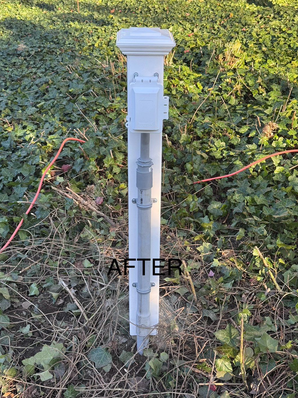 Outdoor receptacle mounted on cedar fence post cov