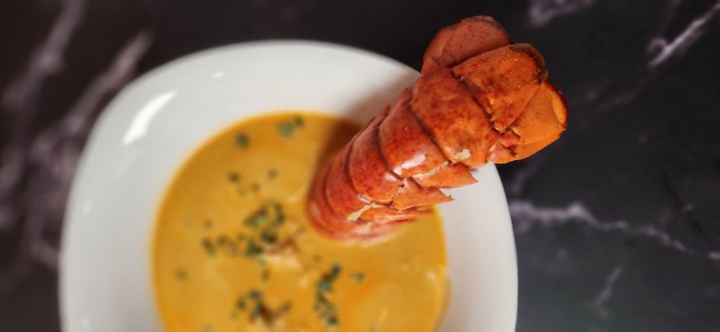 Lobster bisque, with cognac cream and chive oil.