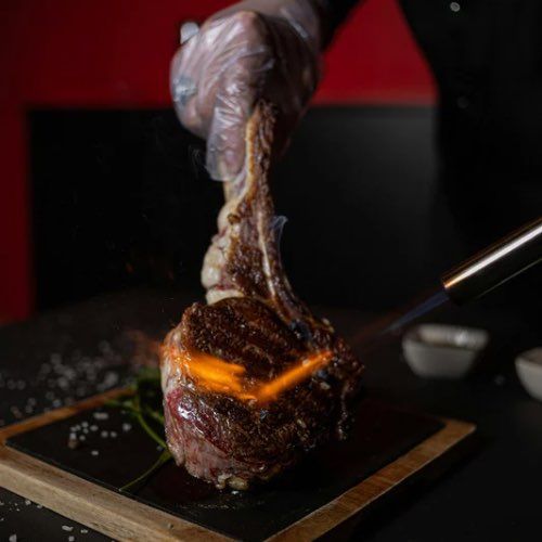 Tableside Tomahawk -flamed, carved and served befo