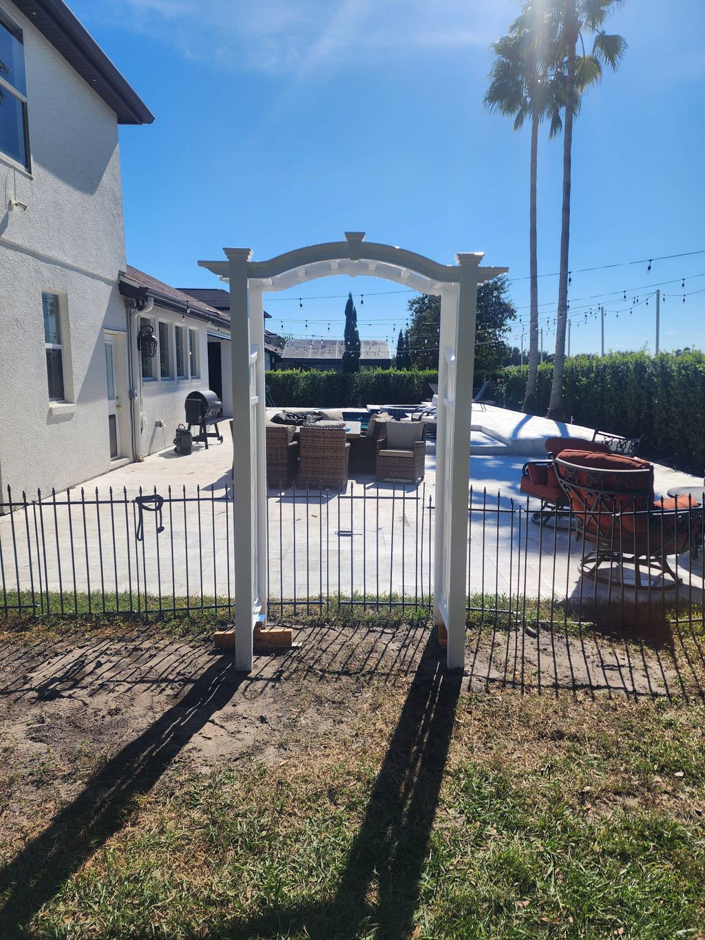 Install Arbor in dog run. centerd on patio, plumb 