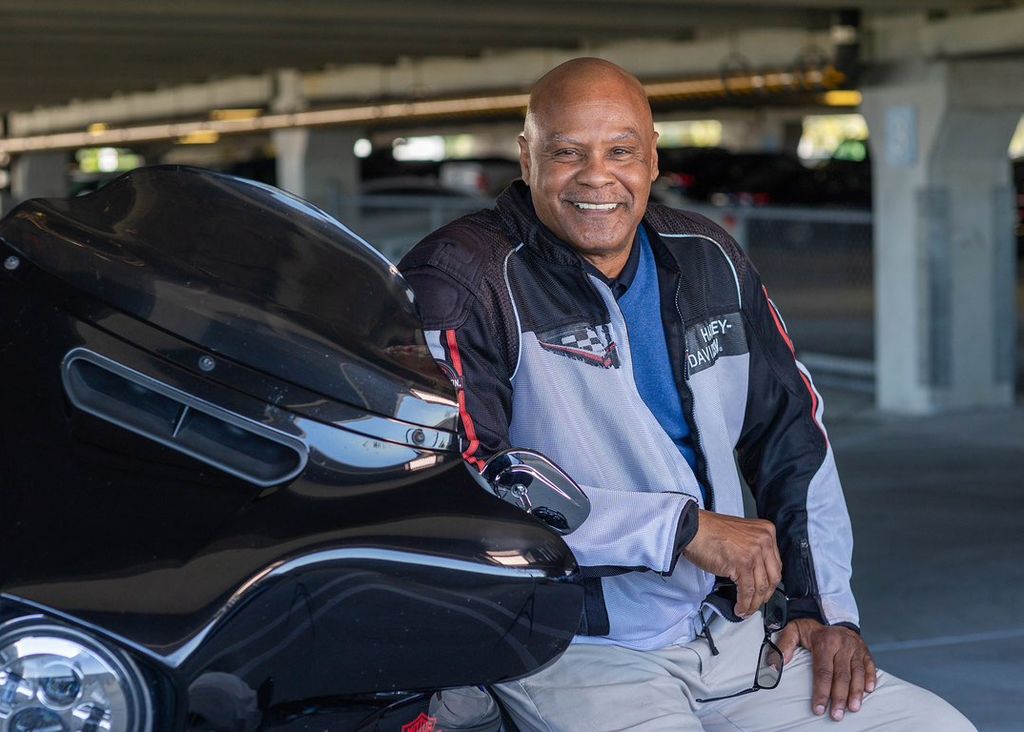 Portrait of Retired guy who likes his bike. He rid