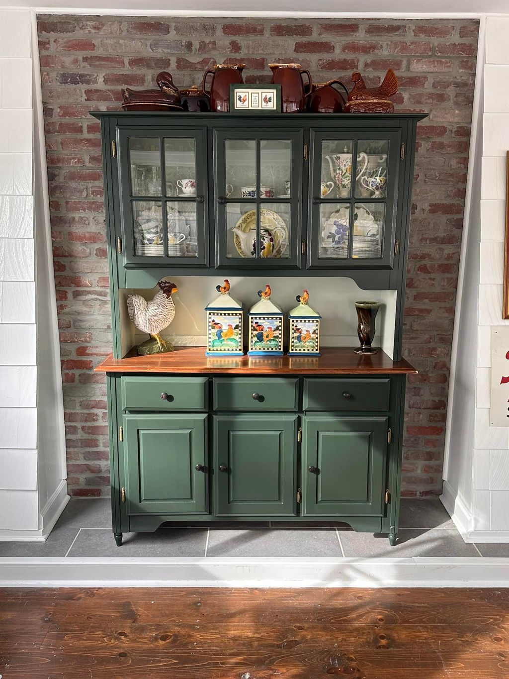 Faux finish brick wall behind refinished cabinet