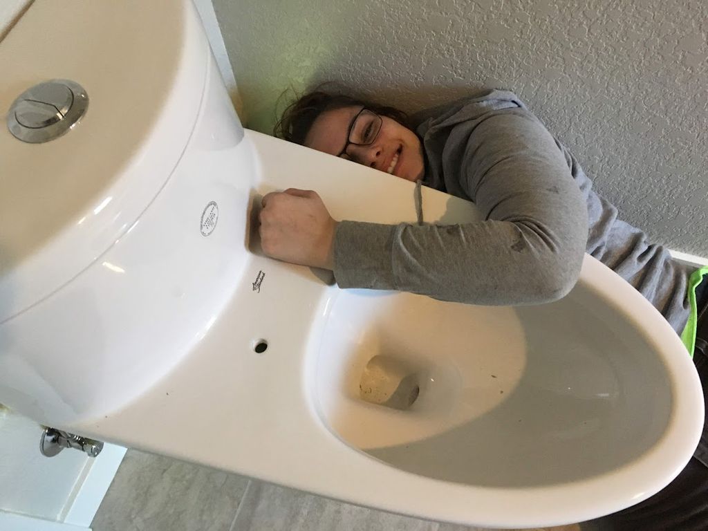 Emma installing one piece toilet