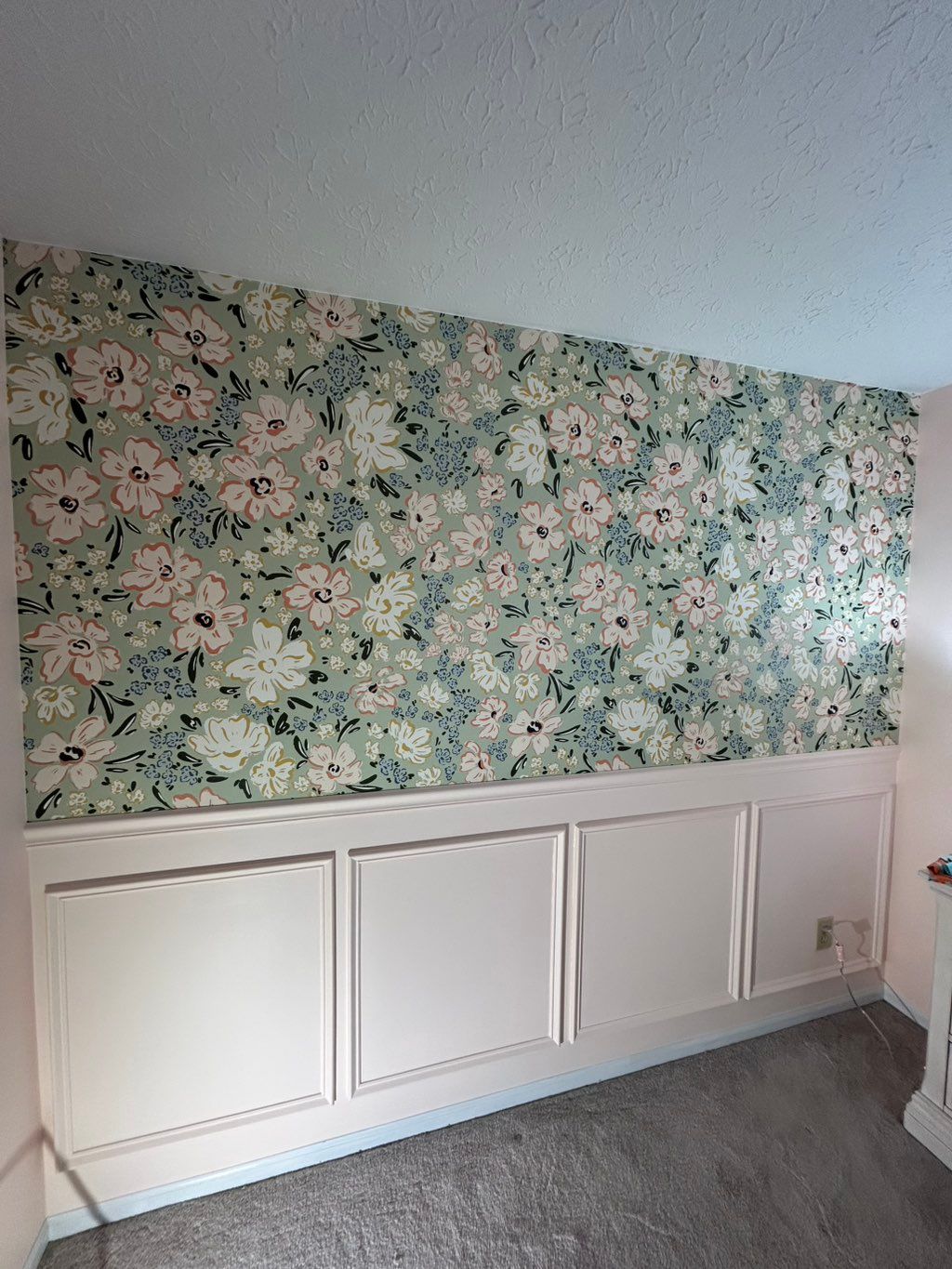 Wall paper and trim installed and painted for nurs