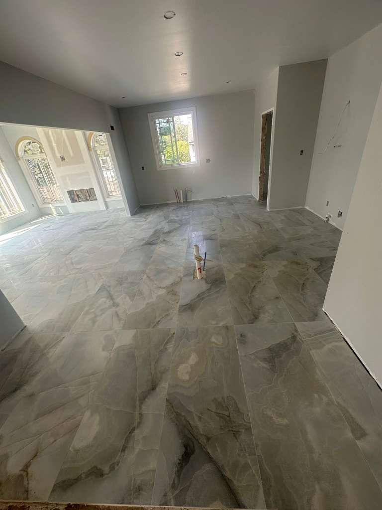 Open space floor tile installation with large form