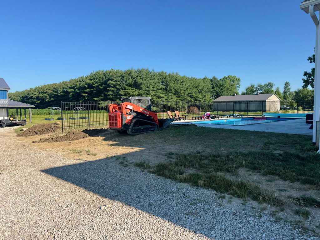 before concrete pad, pool house, and pergola.