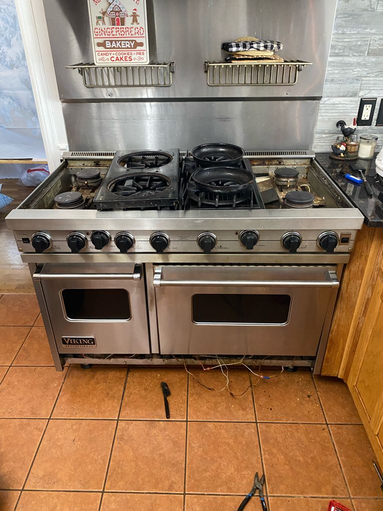 Viking stove had gas smell and clicking burners. W