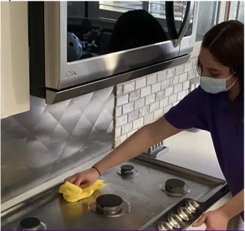 Degreasing and wiping down stovetops as part of a 