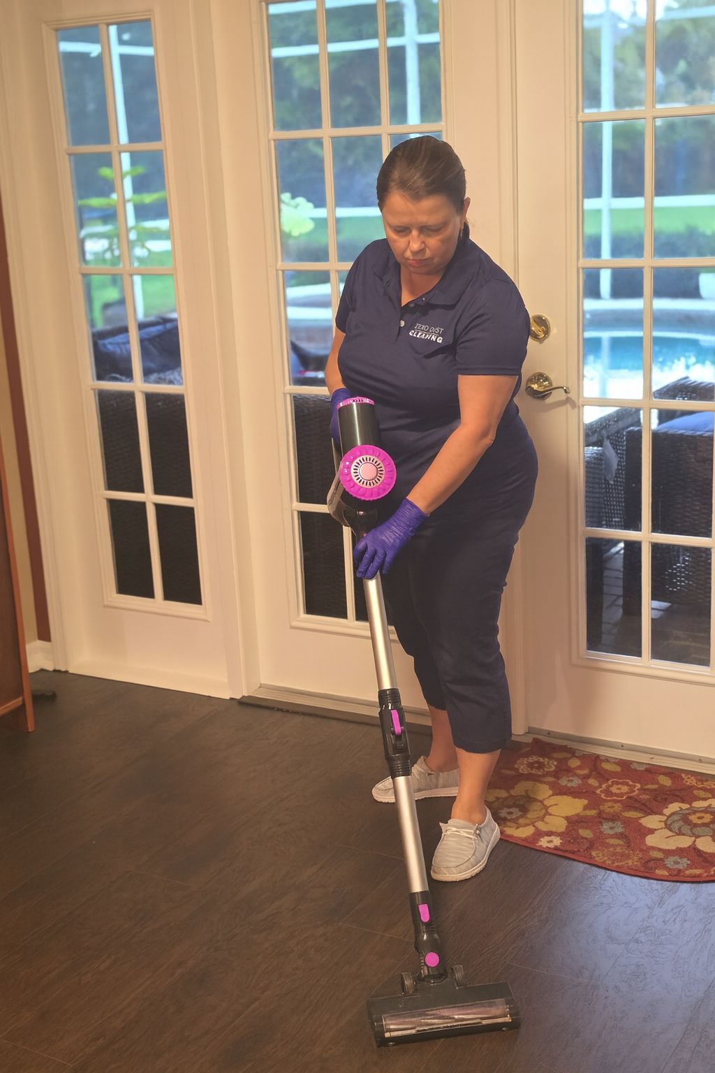 Vacuuming hard floors to remove dust, pet hair, an