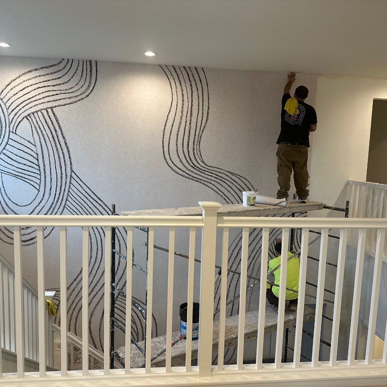 Aguilar’s wallpaper hanging